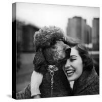 Woman Profiling a Big Smile While Adoring Her Poodle Wearing Large Swiss Watch on Dog Collar-Yale Joel-Stretched Canvas