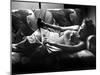 Woman Relaxing on Sofa, Reading and Drinking a Coke-Nina Leen-Mounted Photographic Print