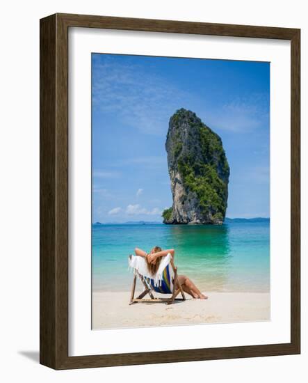 Woman Relaxing on the Beach on a Sunbed in Thailand-Netfalls-Framed Photographic Print