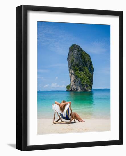 Woman Relaxing on the Beach on a Sunbed in Thailand-Netfalls-Framed Photographic Print