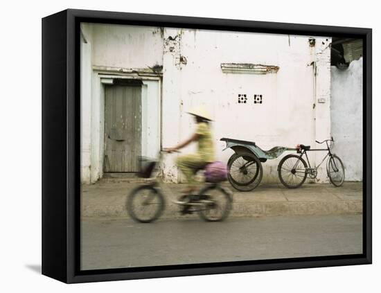 Woman Riding Bicycle Along Street, Ben Tre, Vietnam-Ian Trower-Framed Stretched Canvas