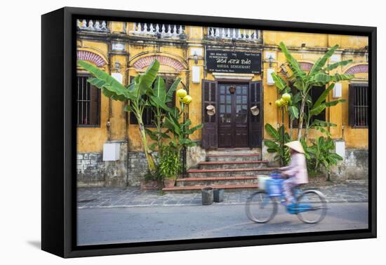 Woman Riding Bicycle Past Restaurant, Hoi an (Unesco World Heritage Site), Quang Ham, Vietnam-Ian Trower-Framed Stretched Canvas