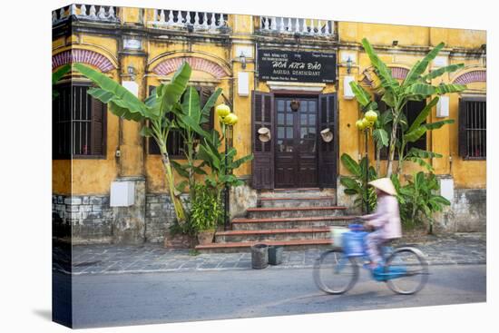 Woman Riding Bicycle Past Restaurant, Hoi an (Unesco World Heritage Site), Quang Ham, Vietnam-Ian Trower-Stretched Canvas