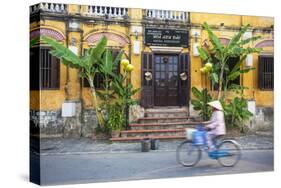 Woman Riding Bicycle Past Restaurant, Hoi an (Unesco World Heritage Site), Quang Ham, Vietnam-Ian Trower-Stretched Canvas