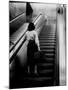 Woman Riding on Escalator in the Time and Life Building-Nina Leen-Mounted Photographic Print