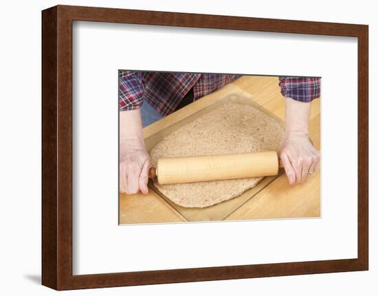 Woman rolling ball of bread dough with a rolling pin, prior to forming it into a loaf.-Janet Horton-Framed Photographic Print