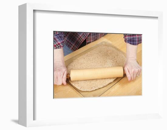 Woman rolling ball of bread dough with a rolling pin, prior to forming it into a loaf.-Janet Horton-Framed Photographic Print