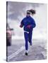 Woman Running During a Snow Storm-null-Stretched Canvas