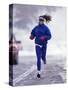 Woman Running During a Snow Storm-null-Stretched Canvas