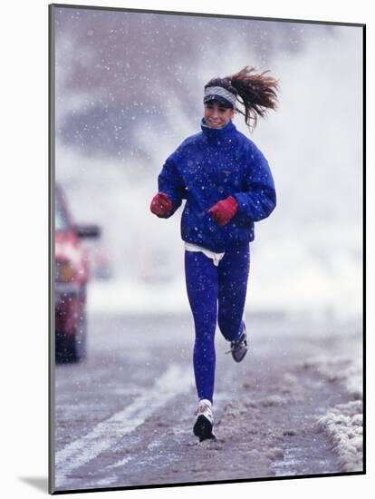 Woman Running During a Snow Storm-null-Mounted Photographic Print