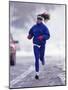 Woman Running During a Snow Storm-null-Mounted Photographic Print