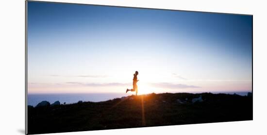 Woman Runs Along a Trail Above the California Coast North of San Francisco-Steven Gnam-Mounted Photographic Print