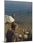 Woman's Back Covered with Mud and People Floating in the Sea in Background, Dead Sea, Israel-Eitan Simanor-Mounted Photographic Print