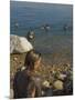 Woman's Back Covered with Mud and People Floating in the Sea in Background, Dead Sea, Israel-Eitan Simanor-Mounted Photographic Print
