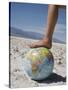 Woman's Foot on Globe, Bad Waters Point, Death Valley National Park, California, USA-Angelo Cavalli-Stretched Canvas