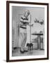 Woman Scrubbing Kitchen Floor with Brushes Attached to Her Feet-Allan Grant-Framed Photographic Print