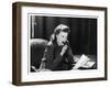 Woman Sits with Her Pen in Her Mouth Whilst Thinking About What She Should Write in Her Letter-null-Framed Art Print