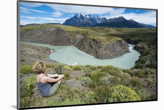 Woman Sitting Above a River Bend in Front of the Torres Del Paine National Park-Michael Runkel-Mounted Photographic Print