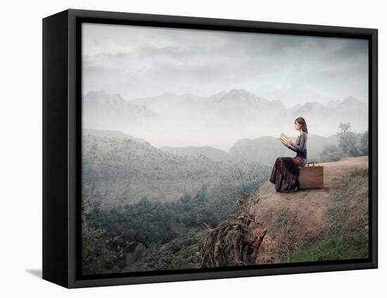 Woman Sitting On A Suitcase And Reading A Book With Landscape On The Background-olly2-Framed Stretched Canvas