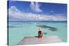 Woman Sitting on Jetty, Fakarava, Tuamotu Islands, French Polynesia (Mr)-Ian Trower-Stretched Canvas