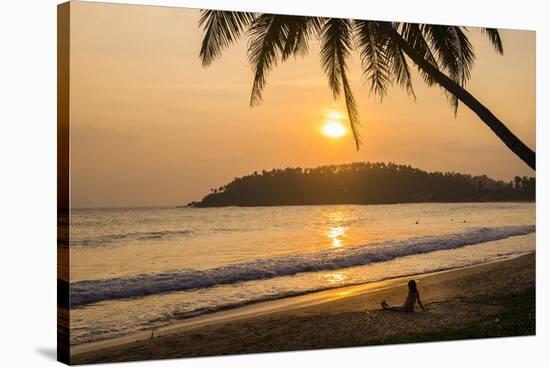 Woman Sitting on Mirissa Beach Watching the Sun Set-Matthew Williams-Ellis-Stretched Canvas