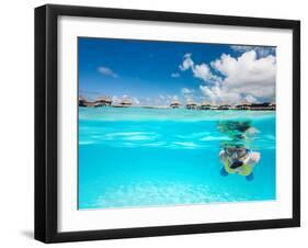 Woman Snorkeling in Clear Tropical Waters in Front of Overwater Villas-BlueOrange Studio-Framed Photographic Print
