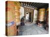 Woman Spinning a Prayer Wheel, Jambay Lhakhang, Built 659 by Tibetan King Songtsen Gampo, Bhutan-Christian Kober-Stretched Canvas