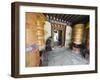 Woman Spinning a Prayer Wheel, Jambay Lhakhang, Built 659 by Tibetan King Songtsen Gampo, Bhutan-Christian Kober-Framed Photographic Print