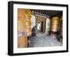 Woman Spinning a Prayer Wheel, Jambay Lhakhang, Built 659 by Tibetan King Songtsen Gampo, Bhutan-Christian Kober-Framed Photographic Print