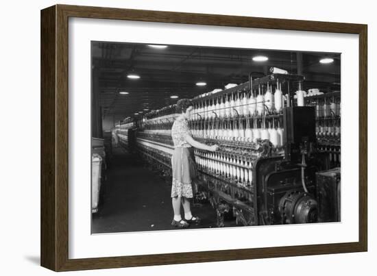 Woman Standing at Long Row of Bobbins, at a Textile Factory-null-Framed Premium Photographic Print