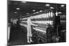 Woman Standing at Long Row of Bobbins, at a Textile Factory-null-Mounted Premium Photographic Print