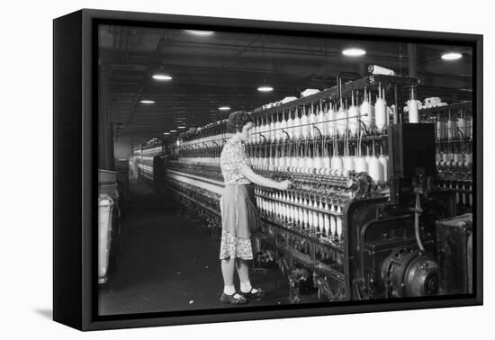 Woman Standing at Long Row of Bobbins, at a Textile Factory-null-Framed Stretched Canvas