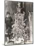 Woman Standing by Decorated Christmas Tree-null-Mounted Photo