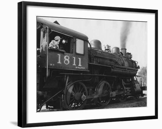 Woman Standing in Driver's Cabin in Locomotive-null-Framed Photo