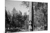 Woman Stands With Her Arms Wrapped Around A Ponderosa Pine Tree Looking Up And Smiling-Hannah Dewey-Mounted Photographic Print