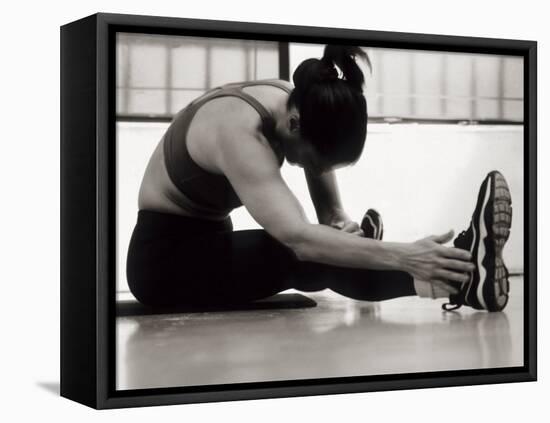 Woman Stretching During a Workout, New York, New York, USA-Paul Sutton-Framed Stretched Canvas