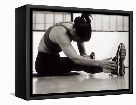 Woman Stretching During a Workout, New York, New York, USA-Paul Sutton-Framed Stretched Canvas