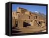 Woman Sweeping Up, in Front of the Adobe Buildings, Dating from 1450, Taos Pueblo, New Mexico, USA-Westwater Nedra-Framed Stretched Canvas