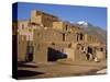 Woman Sweeping Up, in Front of the Adobe Buildings, Dating from 1450, Taos Pueblo, New Mexico, USA-Westwater Nedra-Stretched Canvas