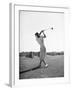 Woman Swinging Golf Club-Philip Gendreau-Framed Photographic Print