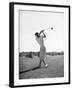 Woman Swinging Golf Club-Philip Gendreau-Framed Photographic Print