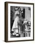 Woman Talking on Wall Mounted Telephone-null-Framed Photographic Print