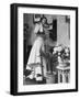 Woman Talking on Wall Mounted Telephone-null-Framed Photographic Print