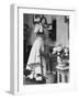 Woman Talking on Wall Mounted Telephone-null-Framed Photographic Print