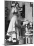 Woman Talking on Wall Mounted Telephone-null-Mounted Photographic Print