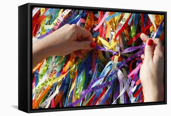 Woman Tying Lucky Ribbon at Igreja Nosso Senhor do Bonfim Church, Salvador, Bahia, Brazil-Yadid Levy-Framed Stretched Canvas