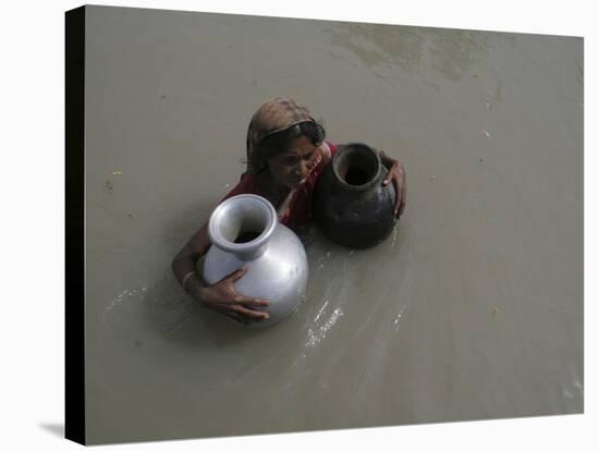 Woman Wades Through Flood Waters to Collect Drinking Water at Kakadhowa Village in India-null-Stretched Canvas