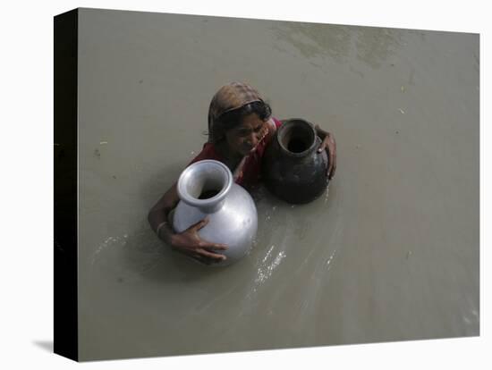 Woman Wades Through Flood Waters to Collect Drinking Water at Kakadhowa Village in India-null-Stretched Canvas