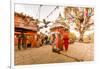 Woman walking and praying with pigeons at the hilltop temple, Bhaktapur, Kathmandu Valley, Nepal, A-Laura Grier-Framed Photographic Print