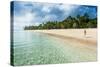 Woman Walking on a Palm Fringed White Sand Beach in Ha'Apai Islands, Tonga, South Pacific-Michael Runkel-Stretched Canvas